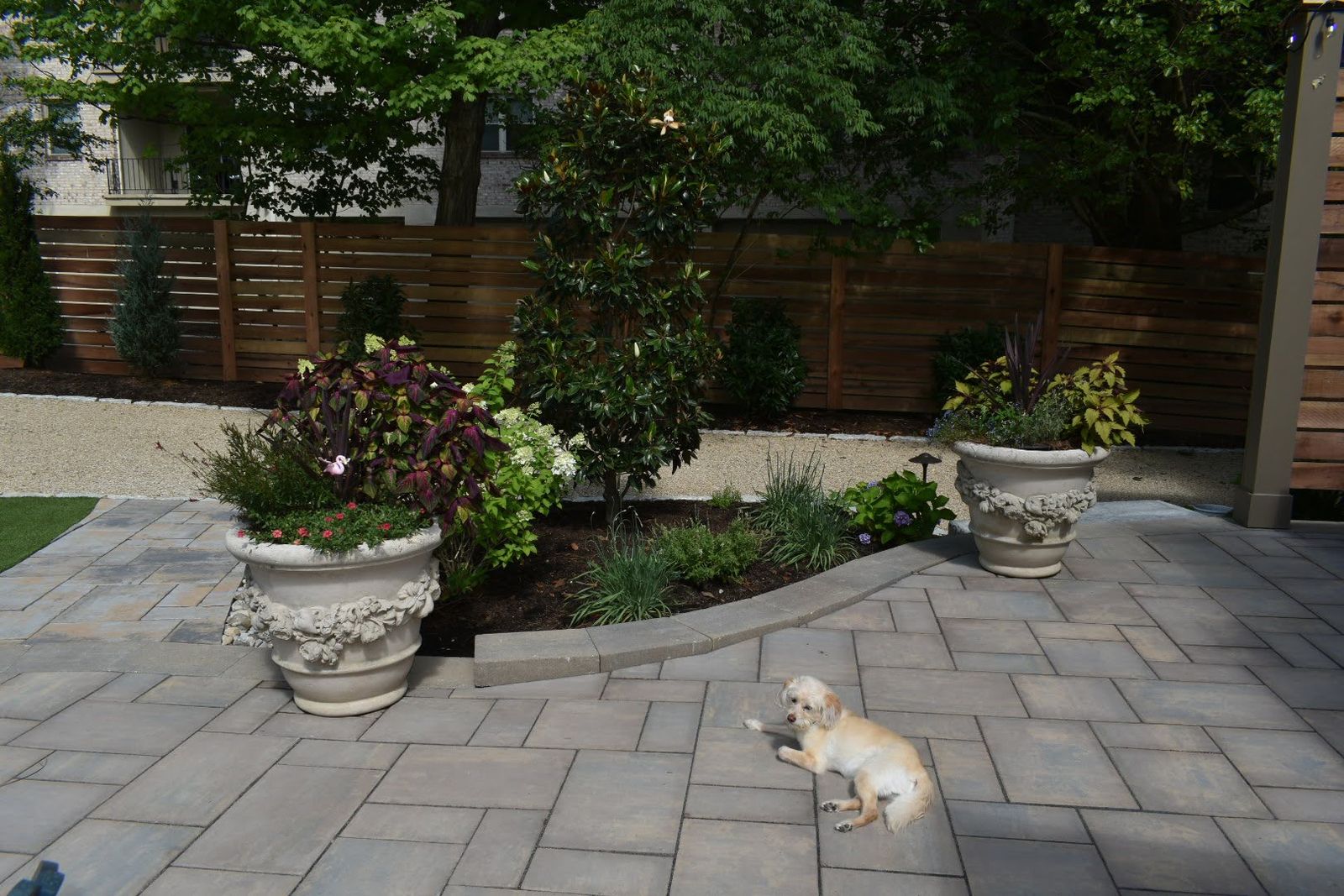 Paver patio with planters and garden beds