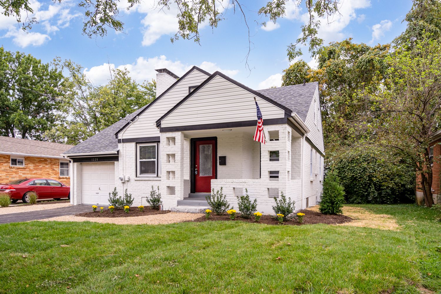 Renovated cottage exterior with new entry and landscaping