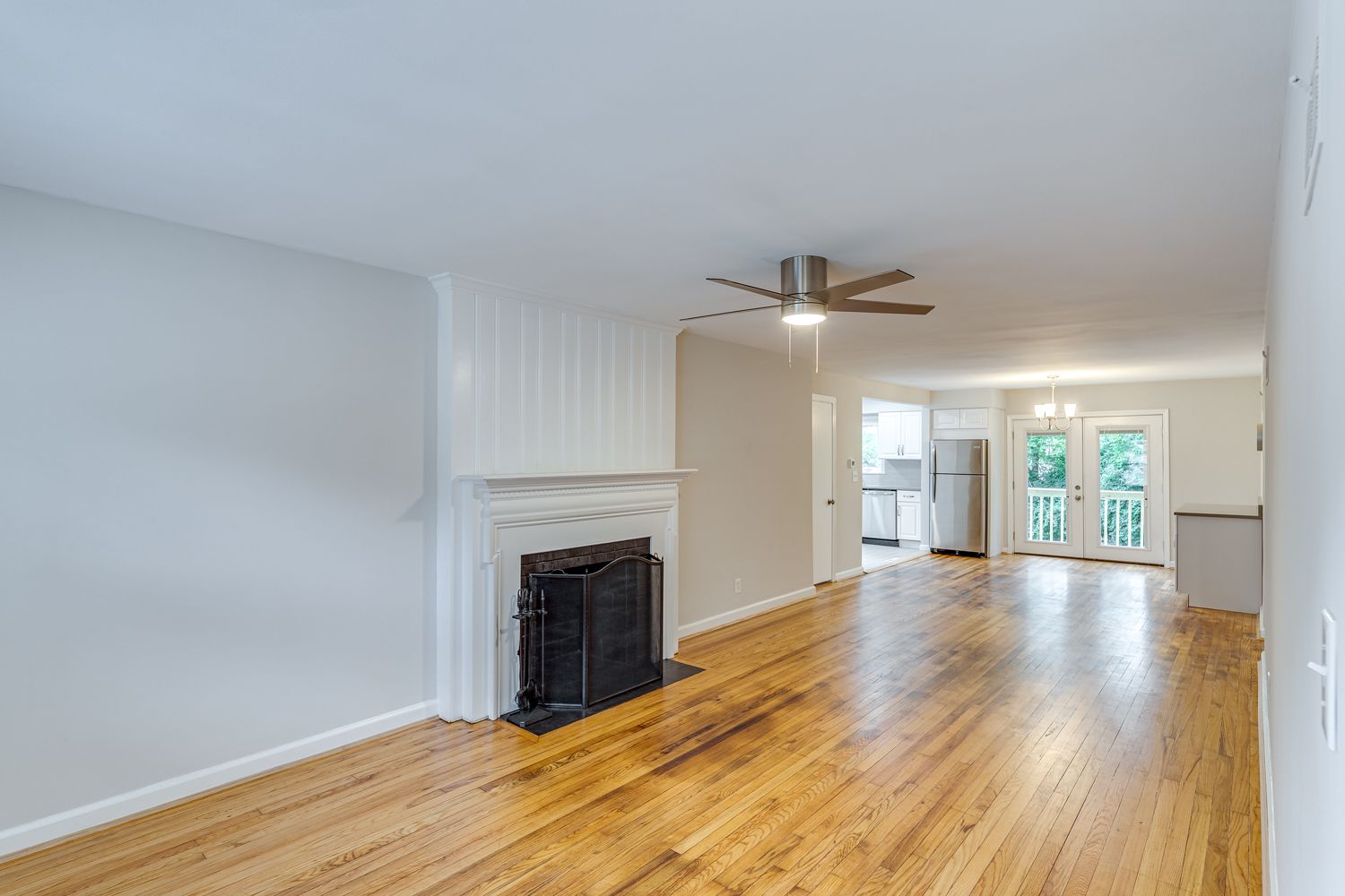 Renovated living room with fireplace and refinished hardwood floors