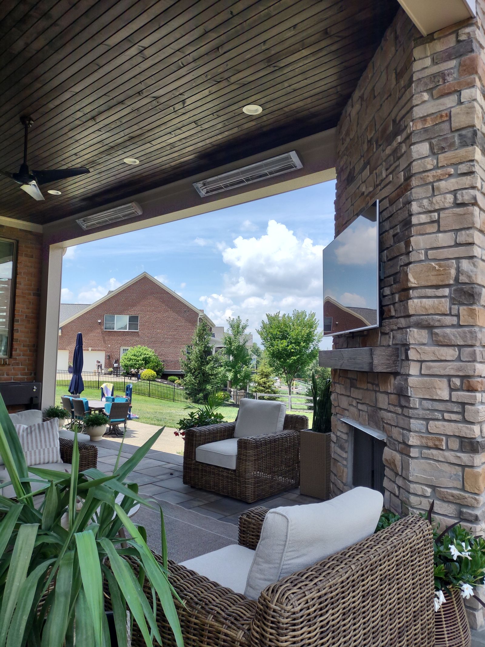 Porch lounge detail with stone fireplace and planters