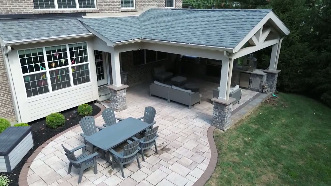 Aerial and ground footage of the covered outdoor kitchen and living room project.