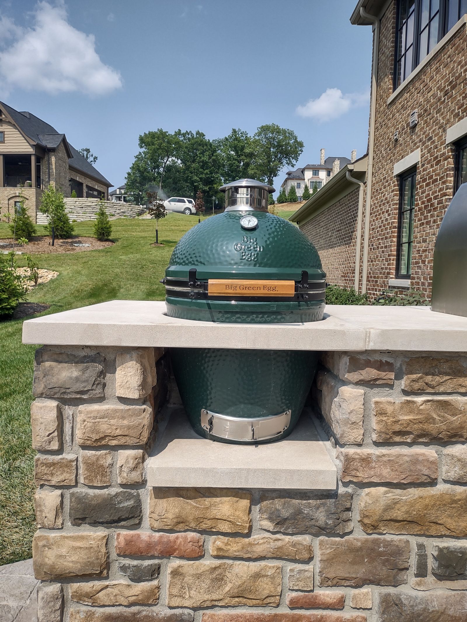 Kamado-style ceramic smoker set into a stone counter