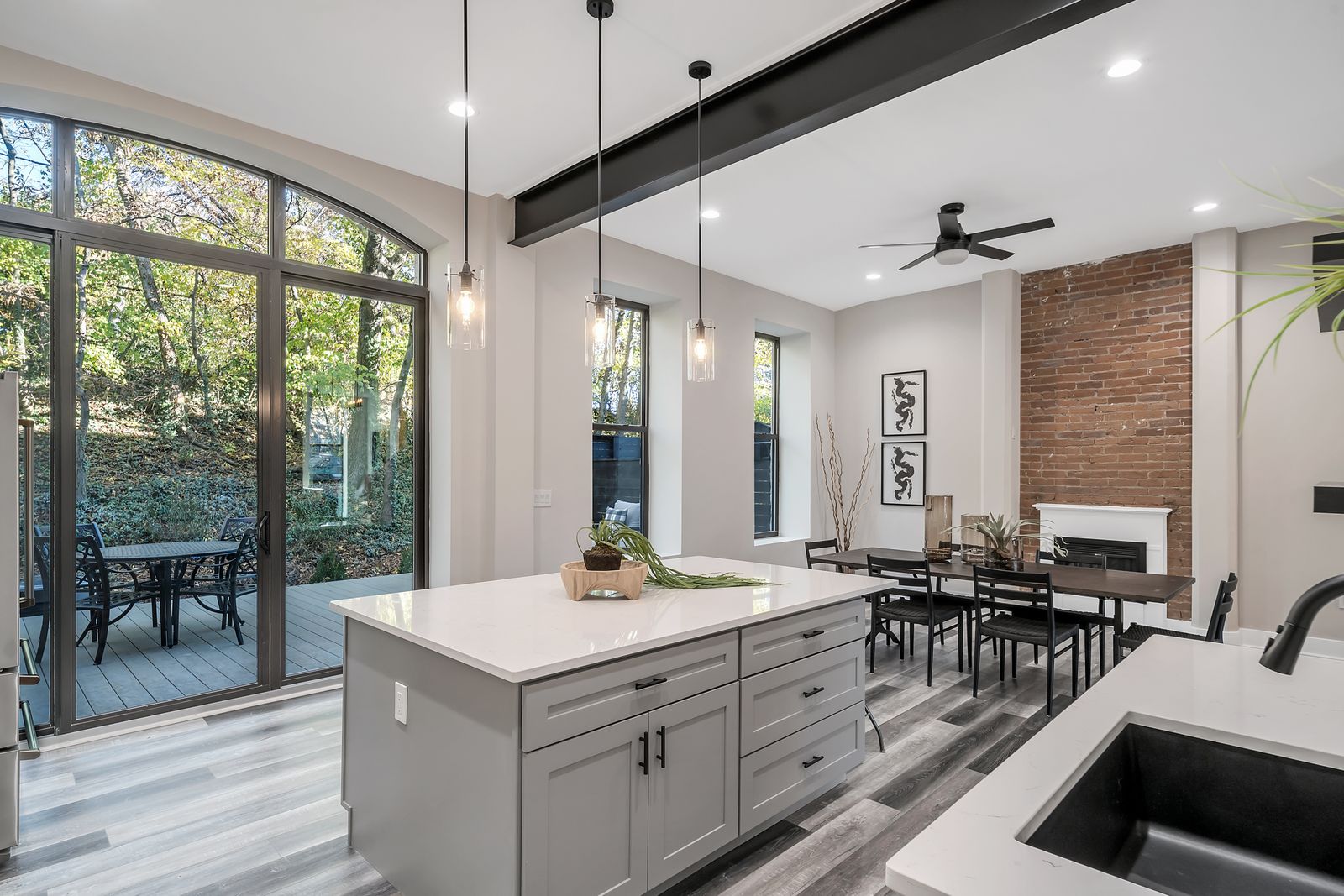 Kitchen island with pendant lighting and garden views