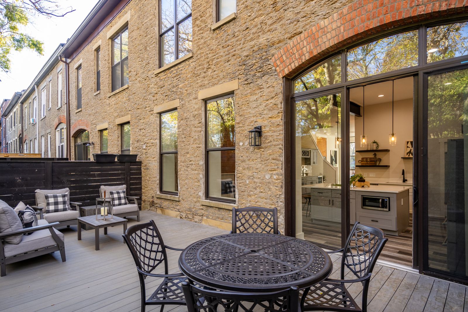 Private brick courtyard with decking and outdoor dining
