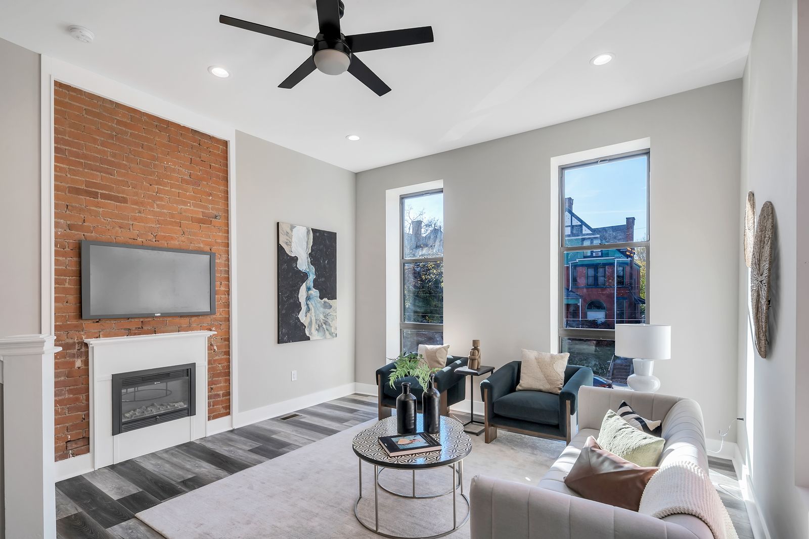Living room with fireplace and brick accent wall