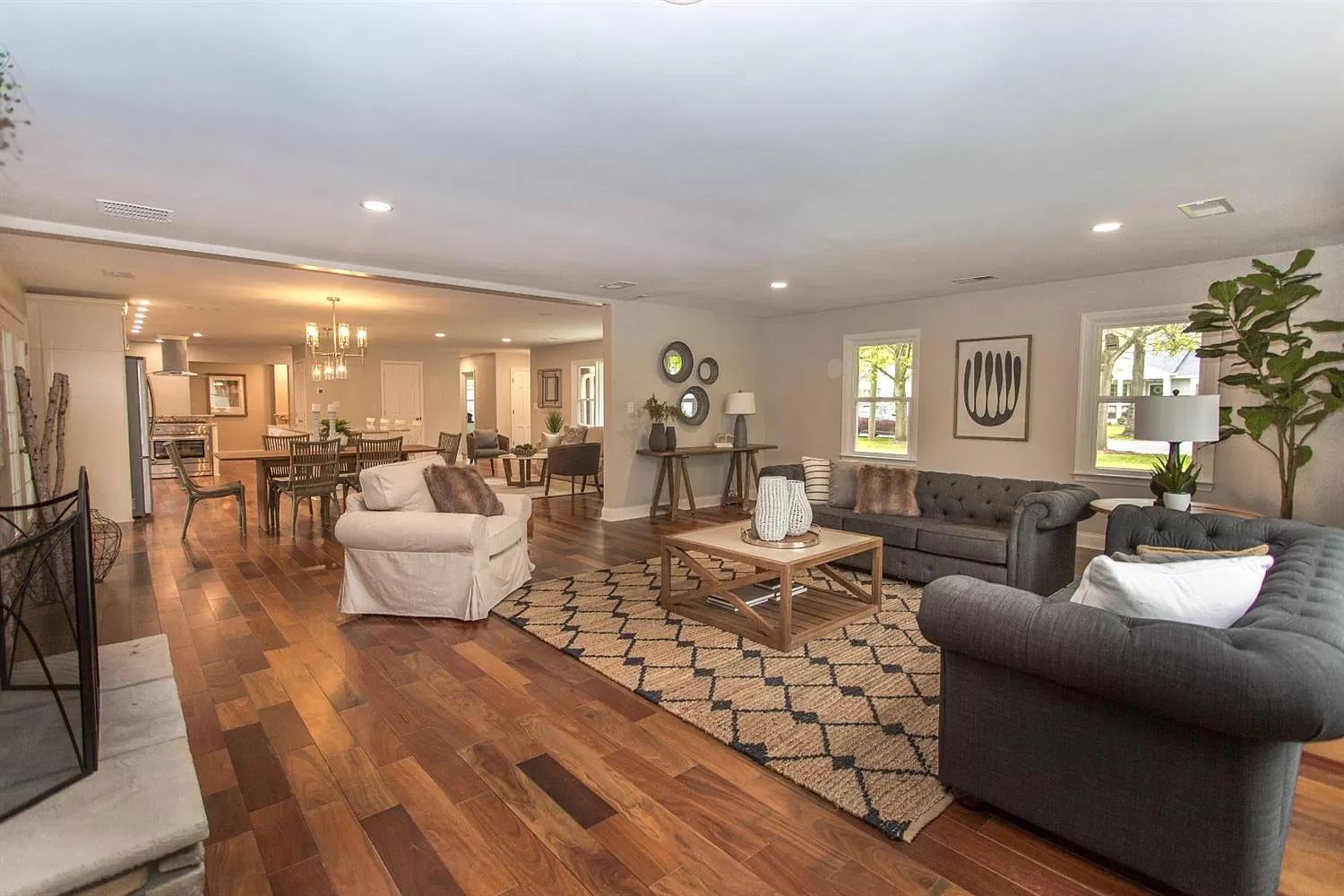 Open living area with hardwood floors and recessed lighting