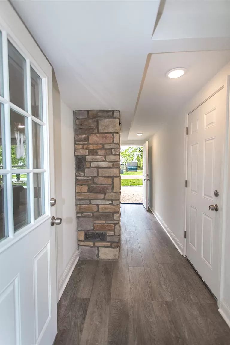 Foyer with stone accent column and view to the entry