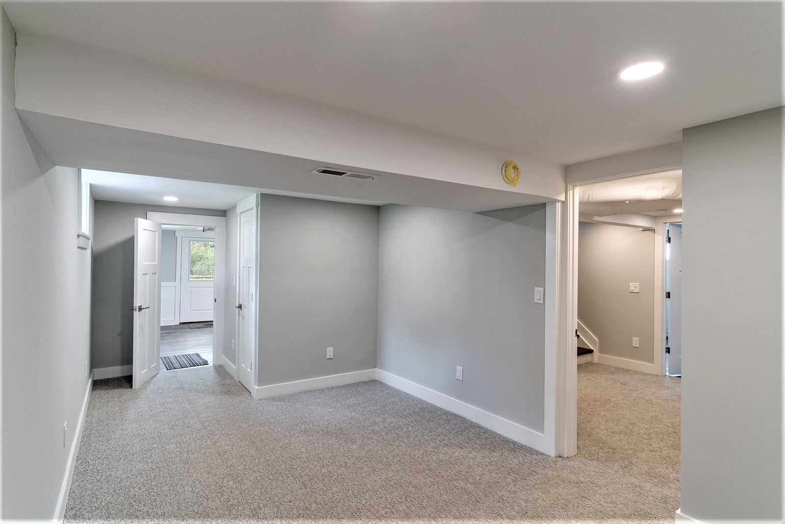 Finished basement rec room with recessed lighting and new carpet