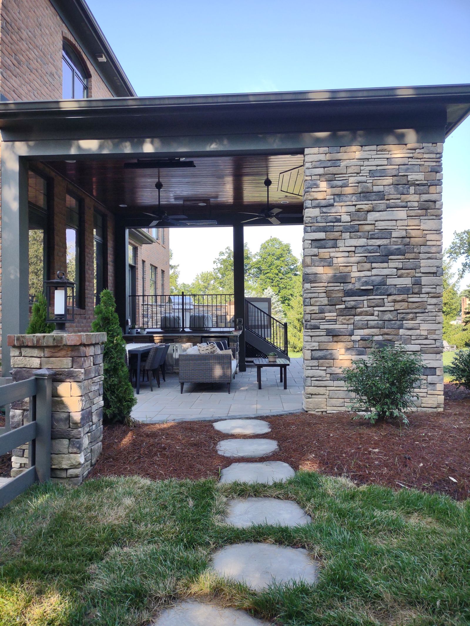Composite deck dining area with black steel railings