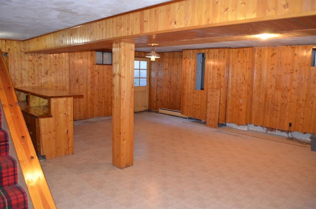 Original wood-paneled basement before finishing