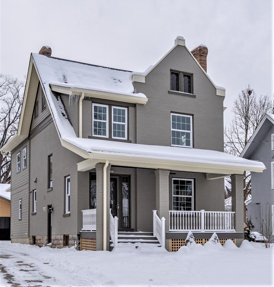 Renovated historic home exterior with covered front porch