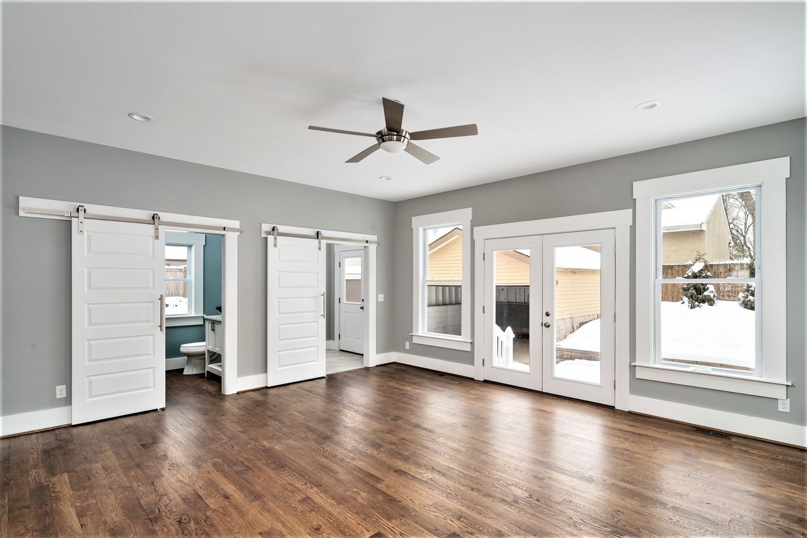 New addition with French doors, sliding barn doors, and backyard views